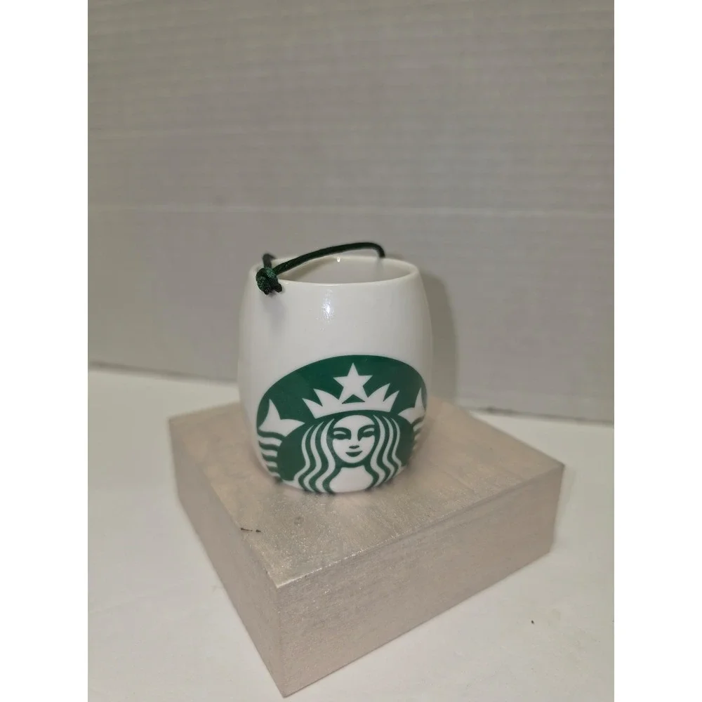 white ceramic Starbucks ornament featuring a green siren logo
